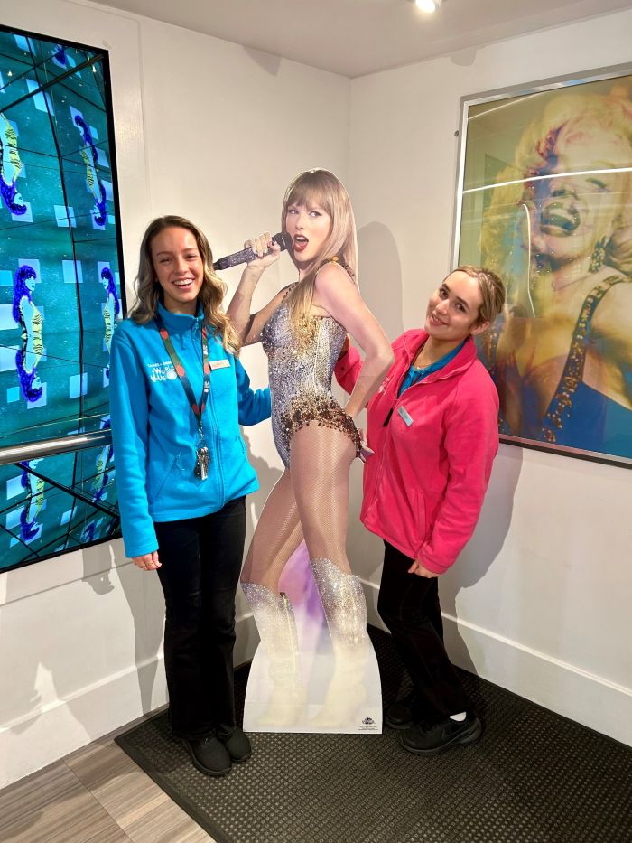 Team members with a cut out of Taylor Swift at Camera Obscura