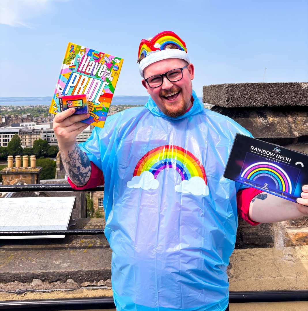 A man with a selection of Pride retail products at Camera Obscura