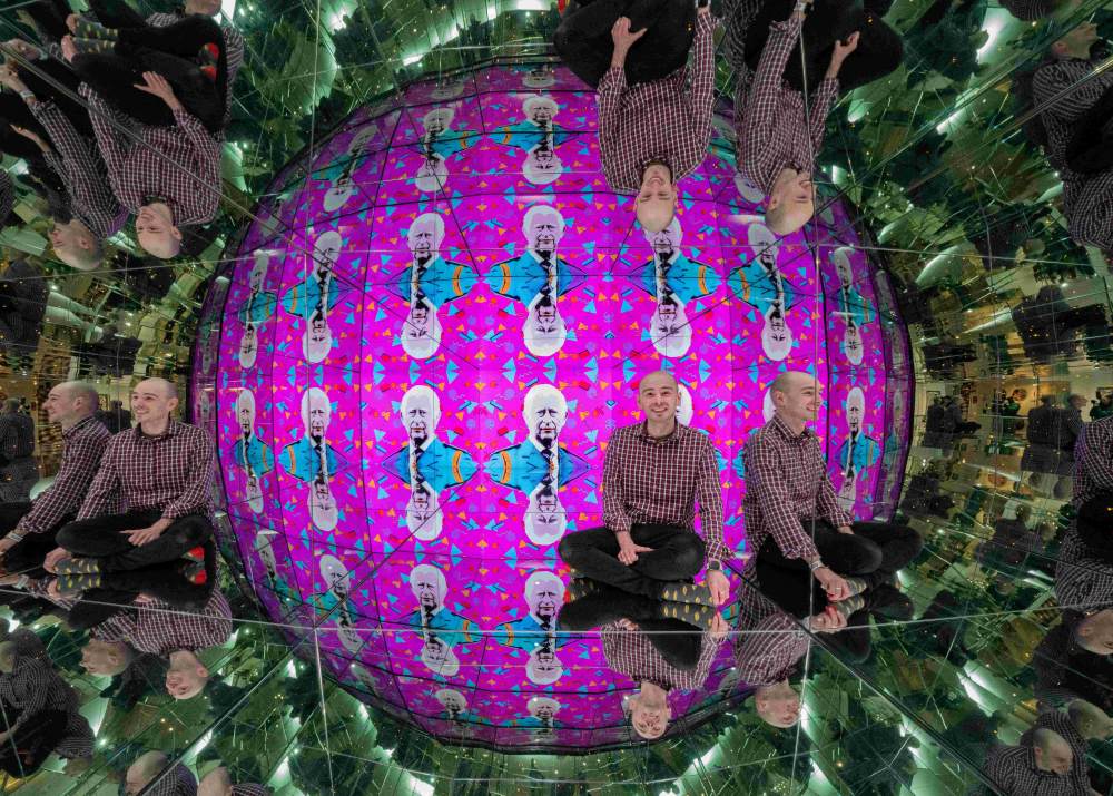 Staff member, Grant, sits in the Giant Kaleidosphere exhibit at Camera Obscura