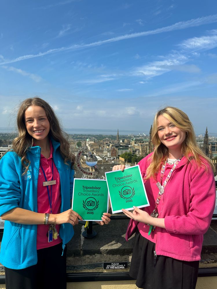 Guides Kirsty and Eve stand on the rooftop at Camera Obscura with the Tripadvisor Travellers Choice Award 2025