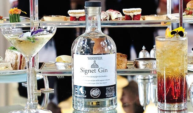 Two glasses with cocktails and a bottle of gin at the Signet Library