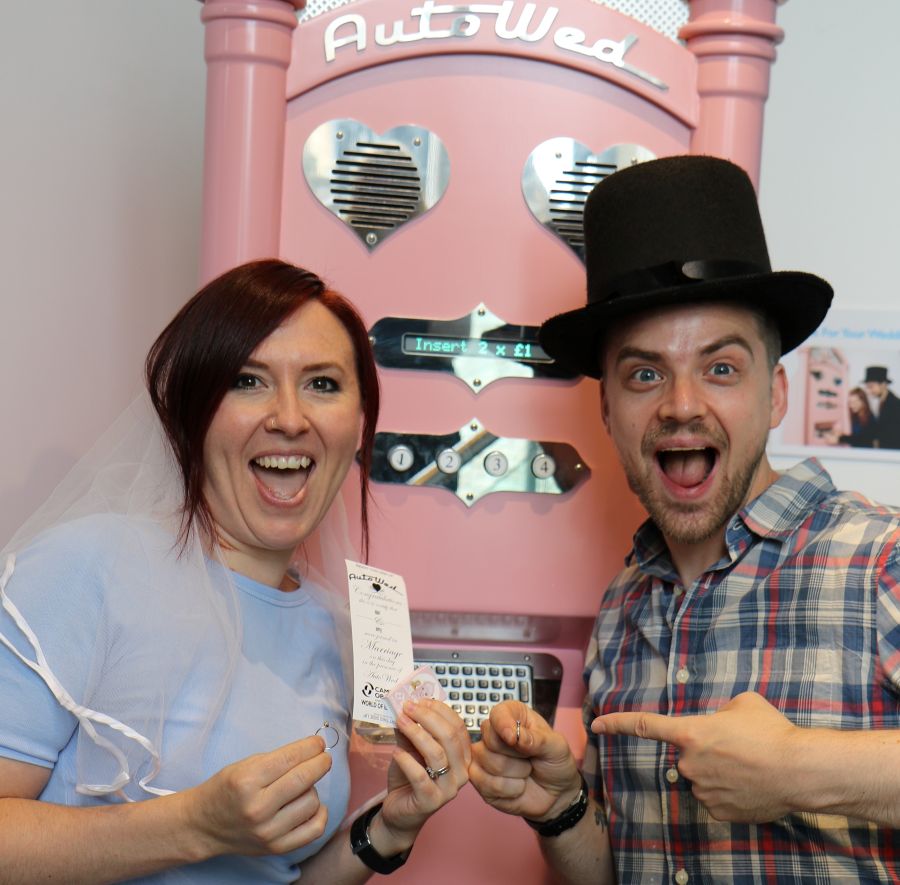 A couple use the AutoWed machine at Camera Obscura and World of Illusions