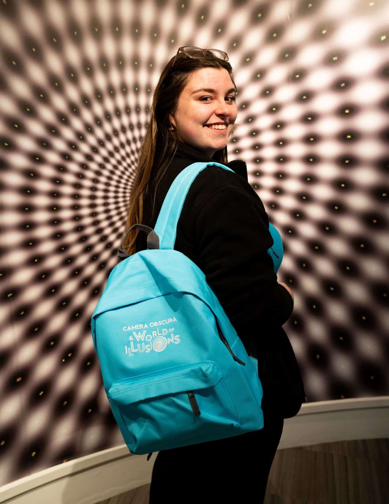 A girl models a sensory backpack at Camera Obscura