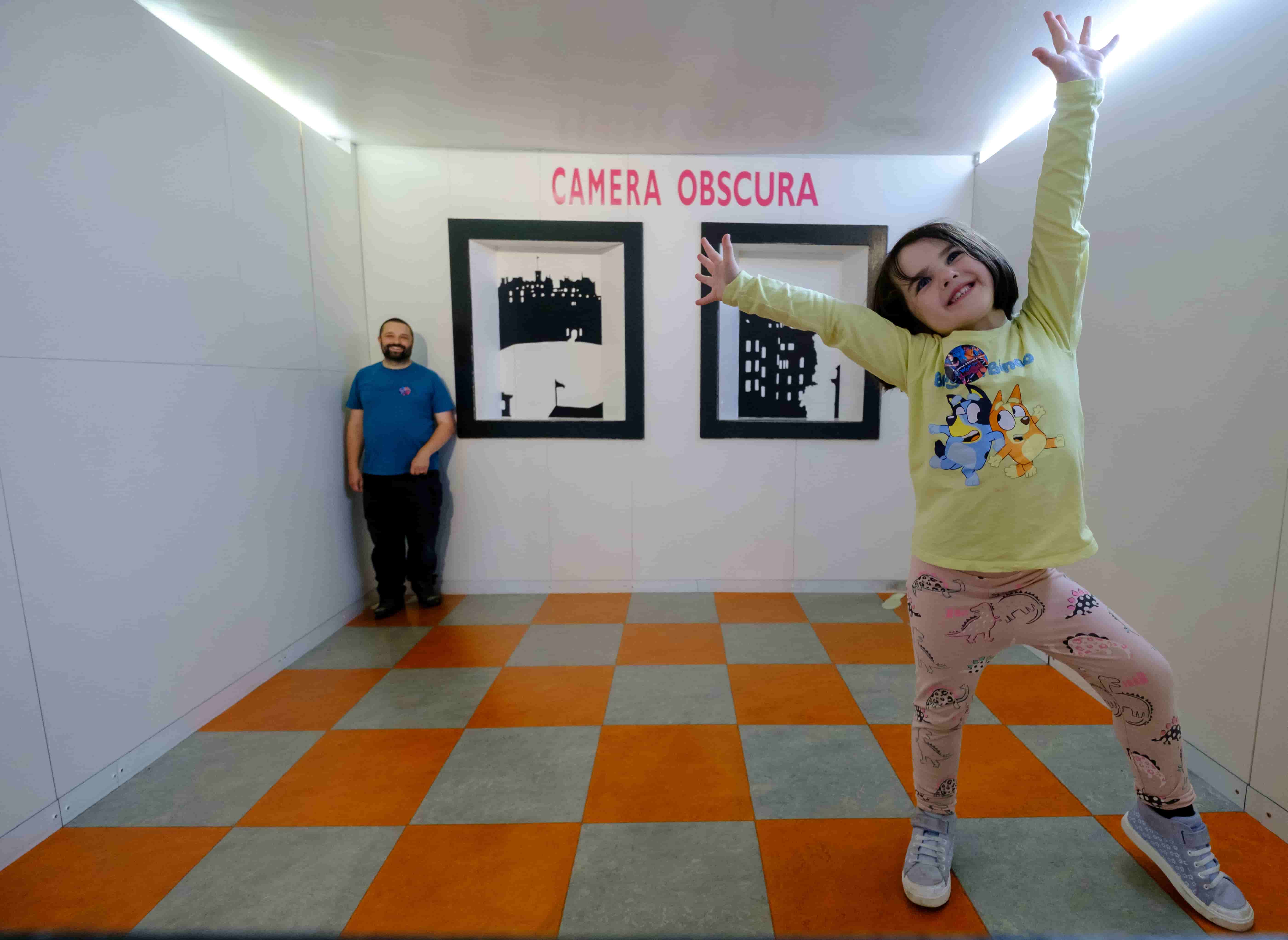 A man and a girl in the Ames Room credit Mike Wilkinson for Forever Edinburgh