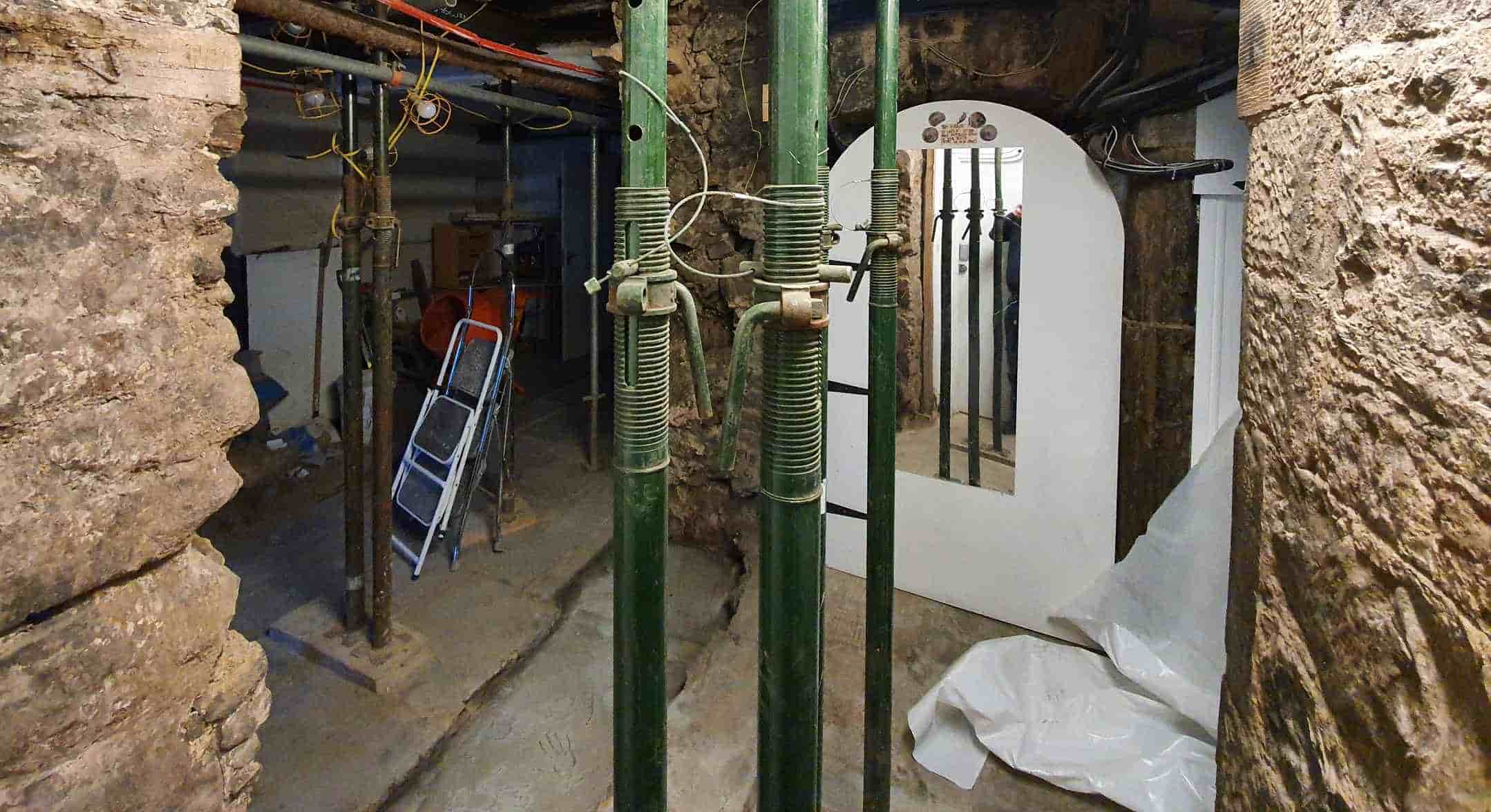 Construction in the basement at Camera Obscura showing exposed walls and structural supports 