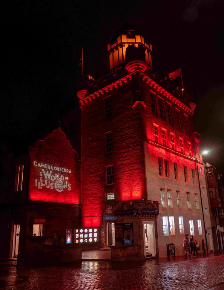 The exterior building of Camera Obscura lit with red lighting