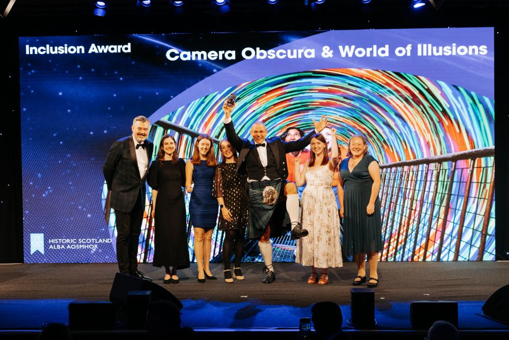 The team from Camera Obscura collect the Inclusion Award on stage at the Thistle Awards. Credit Connor Mollinson VisitScotland