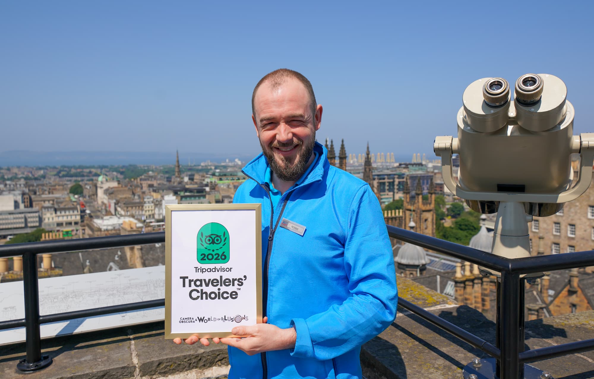 Guide, Robbie, presents Traveller's Choice award on Camera Obscura's Rooftop Terrace