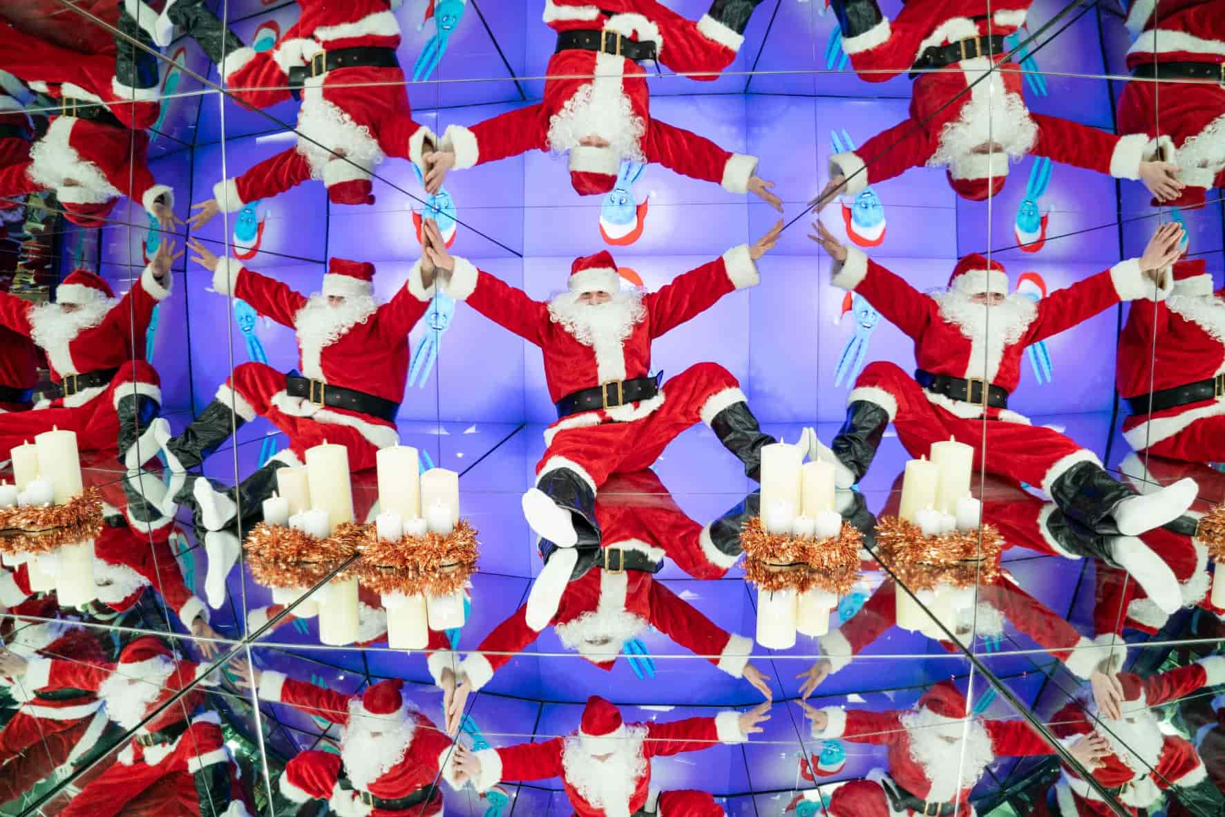 Santa sits in the Giant Kaleidoscope, a mirrored box, reflected many times at Camera Obscura 