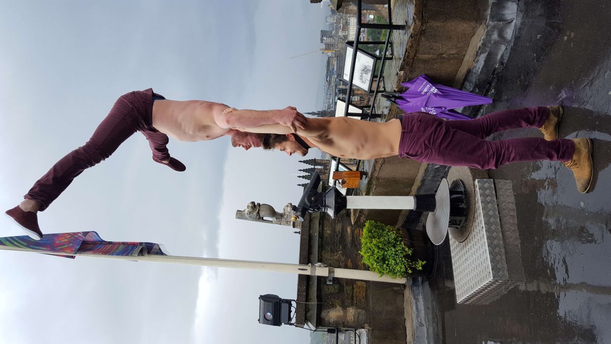 Two acrobats perform a handstand on the Rooftop at Camera Obscura