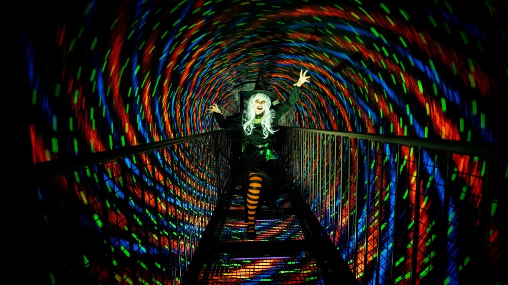 A witch stands in the Vortex Tunnel at Camera Obscura, Edinburgh